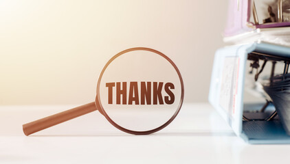 A magnifying glass focused on the word thanks underneath it.