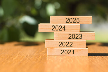 Stacked Wooden Blocks Showing Years 2021 Through 2025 on a Wooden Table