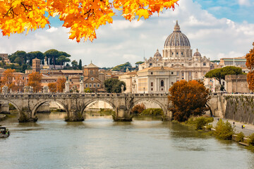 Fototapeta premium St Peter's basilica in Vatican and St. Angel bridge over Tiber river in autumn, Rome, Italy
