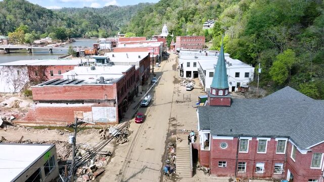 Aerial video over destruction and clean up of downtown Marshall, NC, 1 week after tropical storm Helene flooding.