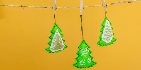 Traditional New Year composition.Festive handmade decor, Christmas trees embroidered with a cross