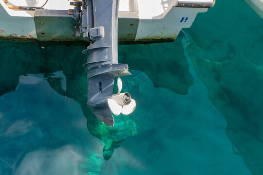 Speed boat at the blue ocean water. Close up of speed boat engine and propeller..