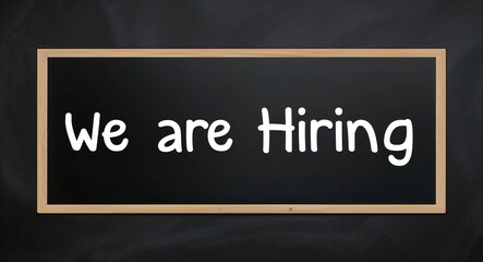 Fototapeta premium we are hiring text lettering on blackboard chalkboard background