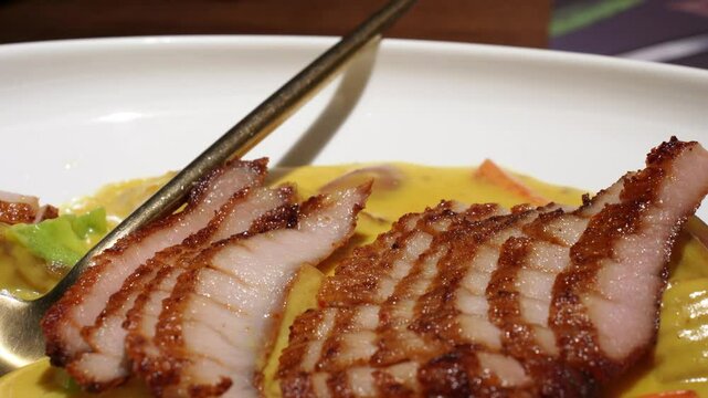 Thai food, sliced pork with curry, close up.