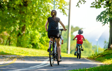 Fototapeta premium Cyclists ride on the bike path in the city Park 
