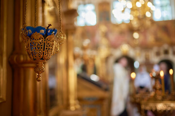 An Ornate Gold Cross Encircled by Colorful Candles Within a Beautiful Church Interior