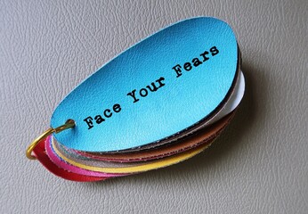 Blue leather with text written FACE YOUR FEARS , motivate oneself to confront with fears, be...