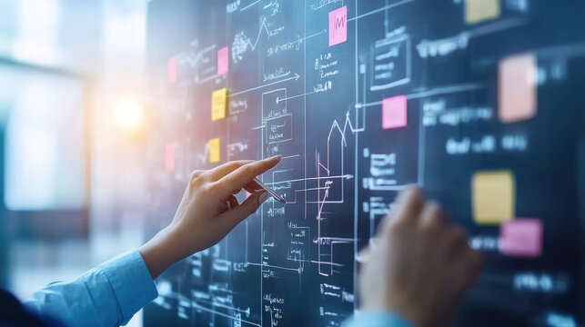 team is engaged in planning company rebranding strategy, analyzing charts and notes on board. atmosphere is focused and collaborative, highlighting importance of teamwork