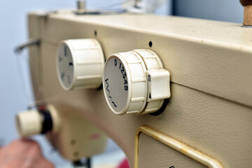 Close-up of the sewing machine's mode control knobs.