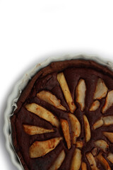 Top view of homemade Chocolate tart with sweet pear fruits in a bake pan isolated on white background