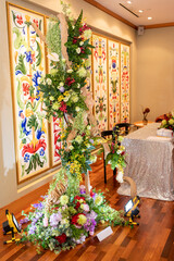 luxury color theme wedding solemnisation dinner flower florist , dinnerware banquet, cloth and stage lighting decoration design in premium hotel ballroom and beautiful beach event