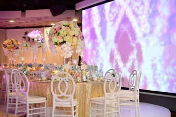 luxury color theme wedding solemnisation dinner flower florist , dinnerware banquet, cloth and stage lighting decoration design in premium hotel ballroom and beautiful beach event