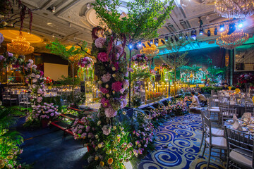 luxury color theme wedding solemnisation dinner flower florist , dinnerware banquet, cloth and stage lighting decoration design in premium hotel ballroom and beautiful beach event