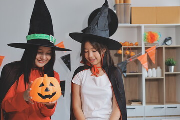 Fototapeta premium friendship, holiday and people concept - group of happy smiling friends in halloween costumes of vampire, devil, witch and cheetah at home party