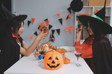 friendship, holiday and people concept - group of happy smiling friends in halloween costumes of...