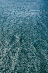 Water texture. Glare and reflective surface water on the lake. Water surface abstract background of a lake or sea water pattern with small waves. Water texture