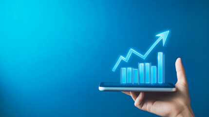 Hand holding smartphone with rising arrow graph on blue background