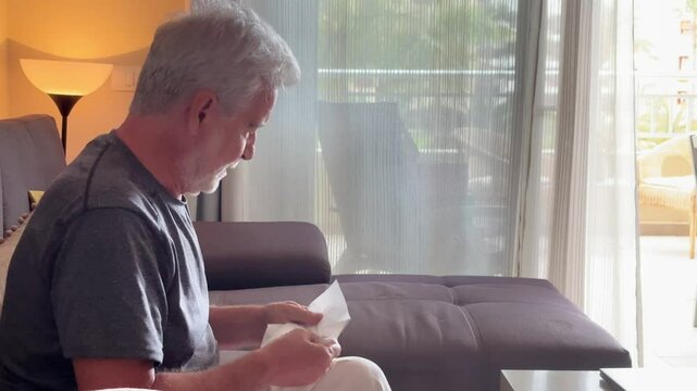 A touching portrayal of an elderly widower crying on his sofa at home, grappling with grief and the isolation that comes with aging. This video captures the deep emotional struggles of senior loneline