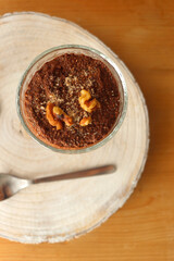 Two bowls of chia seed, chocolate and orange pudding. Healthy snack, wooden background. Top view.