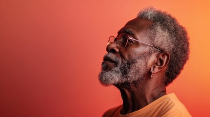 A profile shot of an elderly man with glasses, showcasing a salt-and-pepper beard and warm gradient background, exuding thoughtfulness and introspection. Timeless and regal.