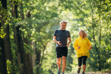 Obraz premium Casual jogging, sport conception. Senior couple together outdoors at nature