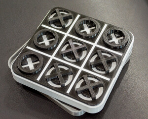 Art object toy Tic Tac Toe printed on 3D printer from white and black plastic. Model created on 3d...