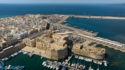Aerial view of Gallipoli Castle, almost completely surrounded by the Ionian Sea, in Salento, Puglia, Italy. The fortress stands at the end of the island where the historic center is located.