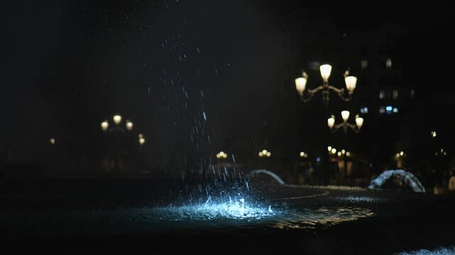 Beautiful view of the city fountain illuminated in the evening. Slow Motion. 4K