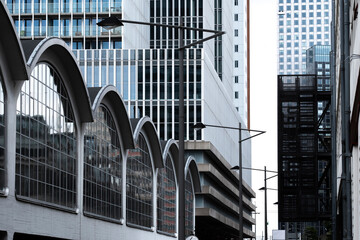 A diverse city architecture scene features a blend of glass and metal elements, highlighting the complex and vibrant interplay of modern urban design and style in Rotterdam