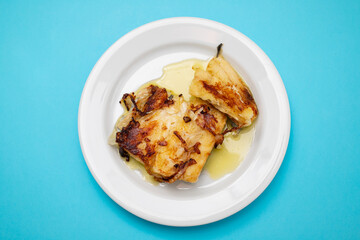 fried cod fish with olive oil on white dish