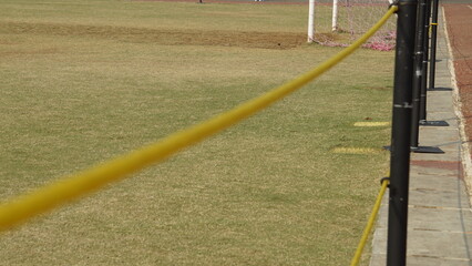Yellow plastic chain that separates the field from the outside of the field
