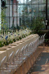 Modern stylish wedding table setting. The wedding decor. The pastel colors flowers bouquet. Natural beautiful wedding decorations. Minimalistic wedding decorations