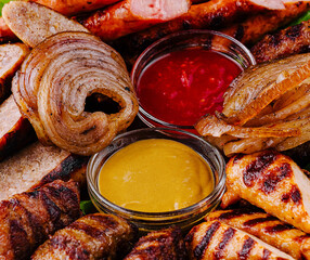 Grilled sausages with cracklings and dipping sauces