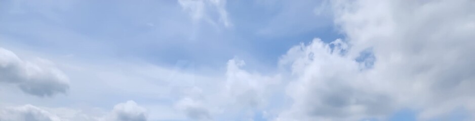 The very bright blue sky was decorated with white clouds. looks very beautiful.