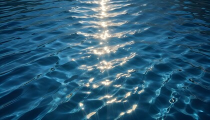 Obraz premium Rippling blue water surface with shimmering sunlight , creating a dynamic and abstract pattern