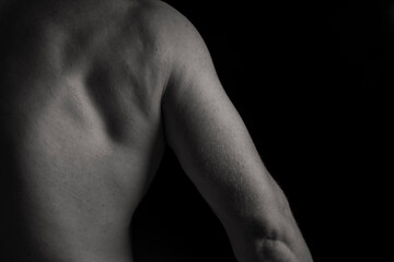 Perfect shoulders and back muscles. Dramatic light