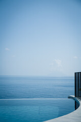 Vies of the tranquil Mediterranean sea from an amazing infinity pool perspective. Blue on blue, water above water, luxury vacation lifestyle.