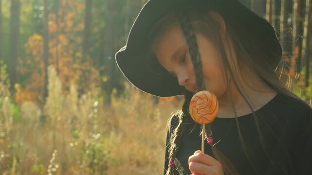 halloween, autumn, girl, witch, portrait, candy, holiday, fall, costume, child, fun, pumpkin, party, little, lantern, jack, hat, happy, childhood, forest, traditional, children, celebrate, spooky, ora