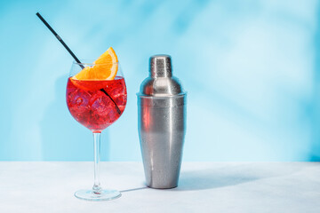 A cocktail arranged on a table against a light blue background