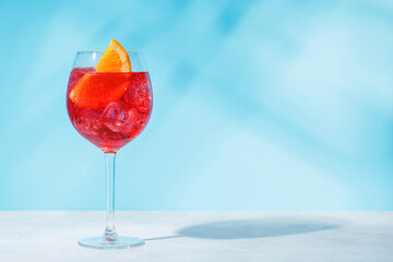 A cocktail arranged on a table against a light blue background