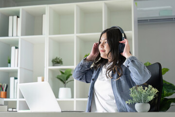 Fat Young Woman with Headphones Performing Audio Assessment in Modern Workspace