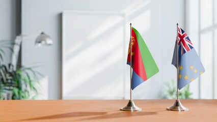 FLAGS OF ERITREA AND TUVALU ON TABLE