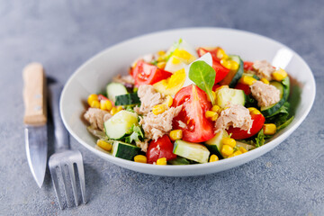 Mixed salad with cucumber, tomato, corn, egg, and tuna. Perfect for nutritious and balanced meal options