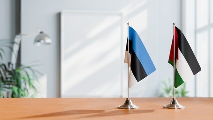 FLAGS OF ESTONIA AND JORDAN ON TABLE