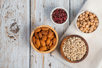 Mung beans, Red kidney beans, Chickpeas source and peeled barley in a basket wooden isolated on wood background