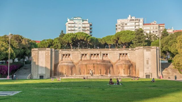 Timelapse hyperlapse of Fonte Luminosa fountain in Alameda Park, Lisbon. Iconic landmark celebrating water supply to the city's eastern district. Residential buildings in view. Portugal