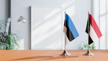 FLAGS OF ESTONIA AND SUDAN ON TABLE