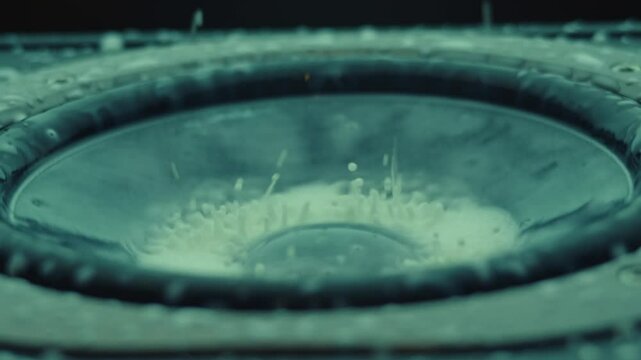 The subwoofer speaker vibrates when playing the deep bass of a music track. The milk vibrates in a pattern and drops bounce.