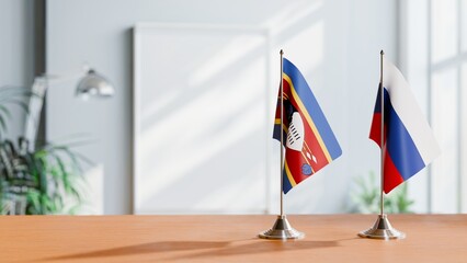 FLAGS OF ESWATINI AND RUSSIA ON TABLE © Vutuk