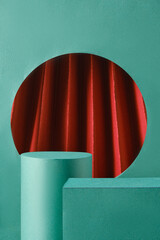 Green podiums and cylinders are part of a simple product display set against a green backdrop. A...